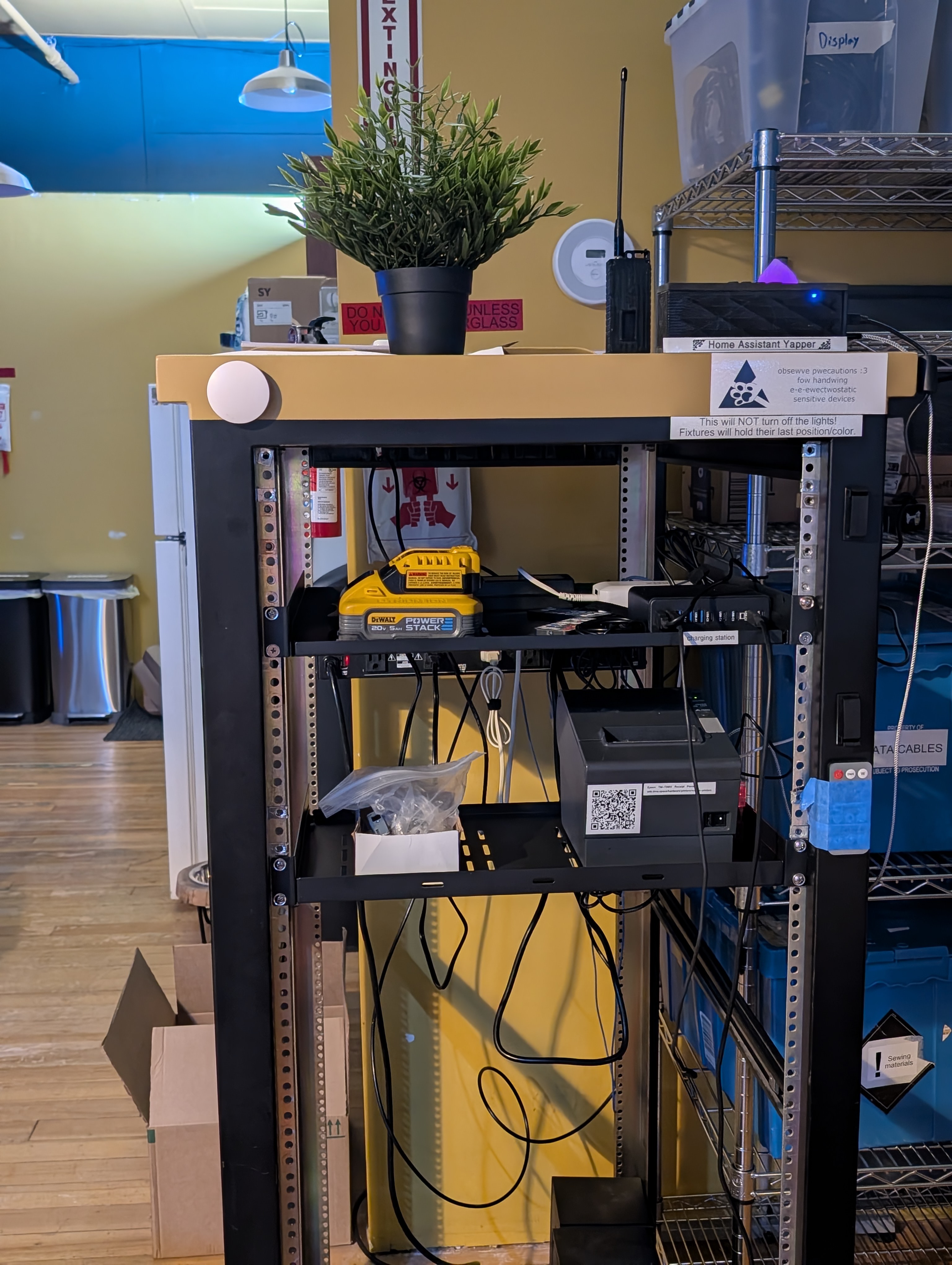 the top part of the member project rack shown. visible in the picture is a receipt printer and a USB-C charger hub labeled "charging station". the top part of the member project rack shown. visible in the picture is a receipt printer and a USB-C charger hub labeled "charging station".